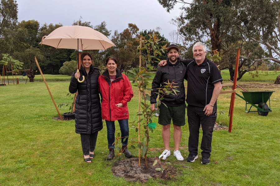 A family in Melbourne planting a memorial tree with their loved one's ashes