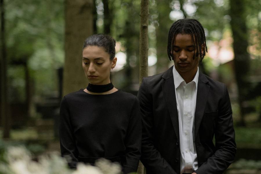 A man and a woman wearing appropriate attire for cremation