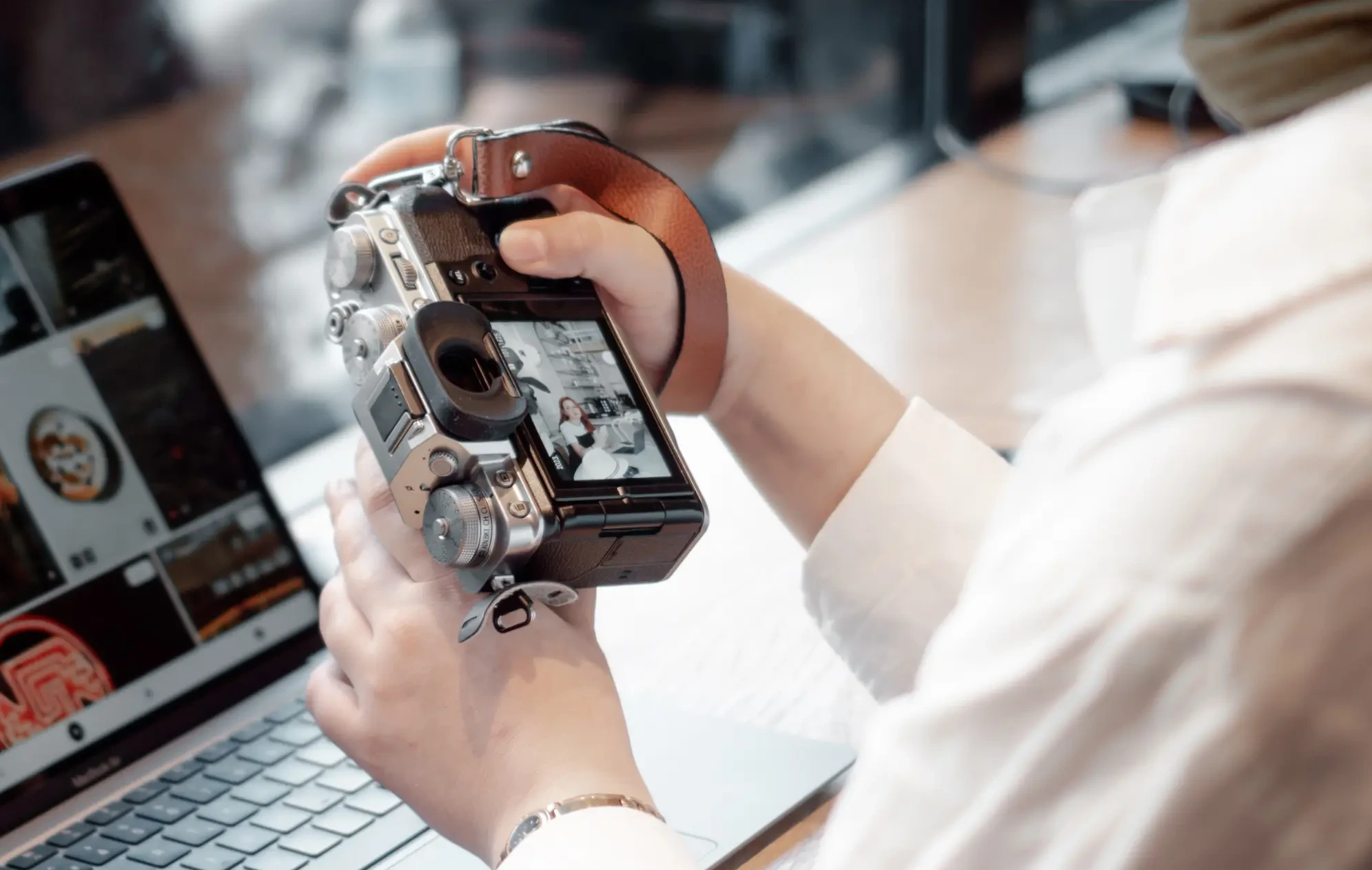 Person using a camera and laptop to curate a digital archive to keep parent's memory alive.