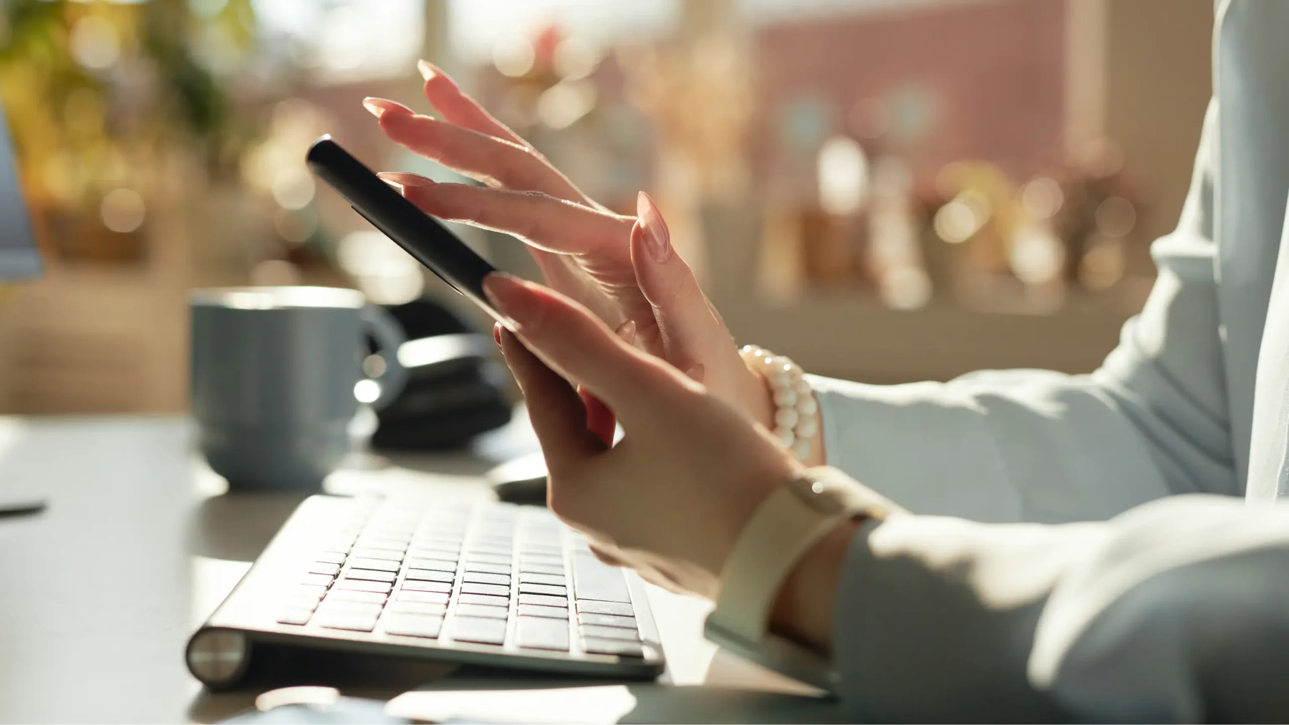 A woman holding a smartphone displaying a digital archive to keep parent's memory alive.